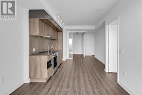 Mississauga (City Centre) condo for rent - A modern kitchen with wooden cabinets and a large island.