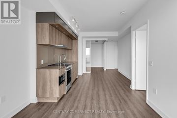 Mississauga (City Centre) condo for rent - A modern kitchen with wooden cabinets and a large island.