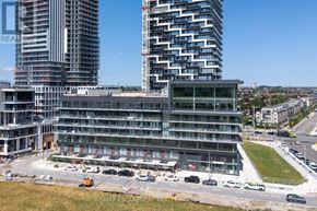 Mississauga (City Centre) condo for rent - A construction site with a large building under construction and a completed building in the background.