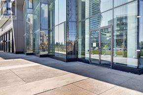 Mississauga (City Centre) condo for rent - A building with glass windows and a sign that says "REALTOR".