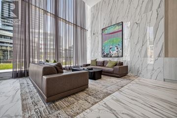 Mississauga (City Centre) condo for rent - A living room with a couch, a coffee table, and a painting on the wall.