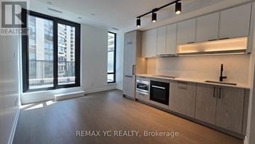 Toronto (Forest Hill South) condo for rent - A well-lit, modern kitchen with wooden cabinets and stainless steel appliances.