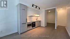 Toronto (Forest Hill South) condo for rent - A brokerage sign is on the wall of a small, empty room.