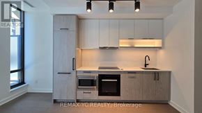 Toronto (Forest Hill South) condo for rent - A kitchen with a sink, oven, and cabinets.