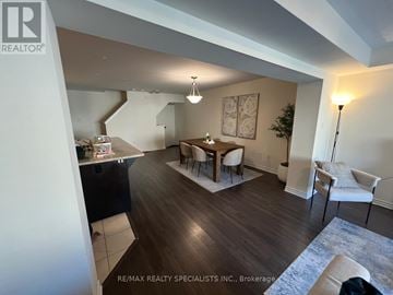 Milton (Fo Ford) townhouse for rent - A living room with a dining table and chairs.