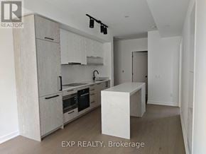 Toronto (Forest Hill South) condo for rent - A kitchen with wooden cabinets and a marble island.