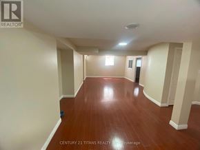 Ajax (Central West) apartment for rent - A spacious room with wooden floors and white walls.