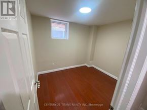 Ajax (Central West) apartment for rent - A room with wooden floors and white walls.