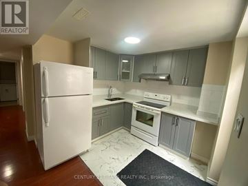 Ajax (Central West) apartment for rent - A kitchen with a white fridge and a stove top oven.