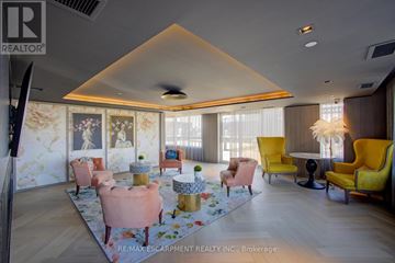 Oakville (Go Glenorchy) condo for rent - A living room with a yellow chair and a pink chair.