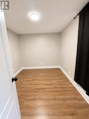St. Thomas fourplex for rent - A room with wooden flooring and a black curtain on the right side.