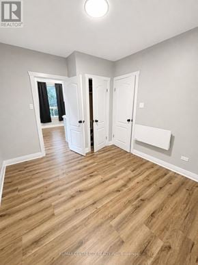 St. Thomas fourplex for rent - A room with wooden flooring and white walls.