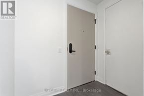 Toronto (Leaside) condo for rent - A white door with a black handle is in a room with white walls.