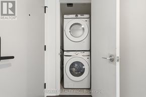 Toronto (Leaside) condo for rent - A white door with a washer and dryer stacked on top of each other.