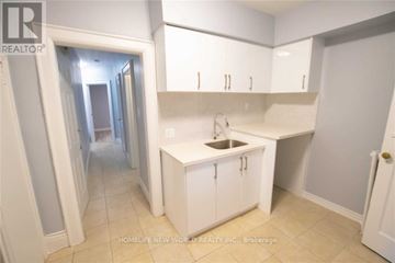Toronto (Dufferin Grove) apartment for rent - A white kitchen with a sink and cabinets.