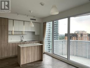 Toronto (Willowdale East) condo for rent - A modern kitchen with wooden cabinets and a large island.