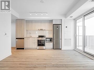 Vaughan (Vaughan Corporate Centre) condo for rent - A modern kitchen with wooden cabinets and stainless steel appliances.