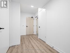 Vaughan (Vaughan Corporate Centre) condo for rent - A white hallway with a door on the left and a door on the right.