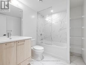 Vaughan (Vaughan Corporate Centre) condo for rent - A white bathroom with a marble wall and a glass shower.