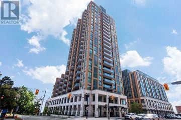 Burlington (Brant) condo for rent - A tall building with many windows is in the center of the image.