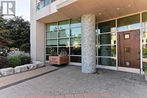 Mississauga (City Centre) condo for rent - The image shows the front of a building with a large glass window and a brown door.