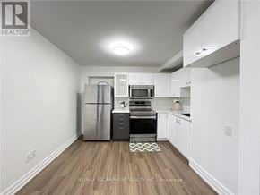 Hamilton (Crown Point) duplex for rent - A kitchen with white cabinets and a wooden floor.