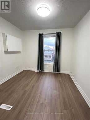 Hamilton (Crown Point) duplex for rent - A room with a window and a wooden floor.