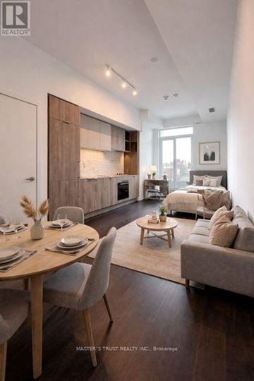 Toronto (Humewood-Cedarvale) condo for rent - A modern living room with a dining table set for two.