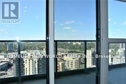 Toronto (Henry Farm) condo for rent - A window with a view of a cityscape and the Realty logo.