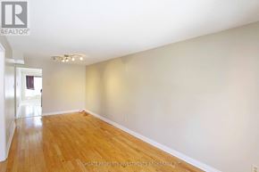 Barrie (Cundles East) apartment for rent - A room with wooden flooring and white walls, with a doorway on the left.