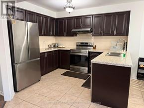 Brampton (Fletcher's Meadow) apartment for rent - A kitchen with a refrigerator, oven, and sink.
