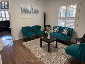 Brampton (Fletcher's Meadow) apartment for rent - A living room with a teal couch, two chairs, and a coffee table.
