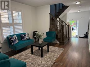 Brampton (Fletcher's Meadow) apartment for rent - A living room with a green couch and a coffee table.