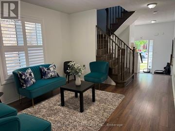 Brampton (Fletcher's Meadow) apartment for rent - A living room with a green couch and a coffee table.