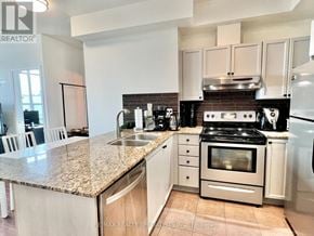 Mississauga (City Centre) condo for rent - A kitchen with a granite countertop and stainless steel appliances.