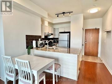 Mississauga (City Centre) condo for rent - A kitchen with a table and chairs in front of it.
