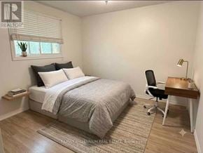 Barrie (Sunnidale) apartment for rent - A bedroom with a bed, chair, and desk.