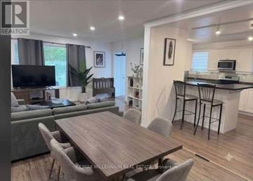 Barrie (Sunnidale) apartment for rent - A modern living room with a wooden dining table and grey chairs.