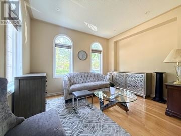 Markham (Cachet) apartment for rent - A living room with a grey sofa and a glass coffee table.