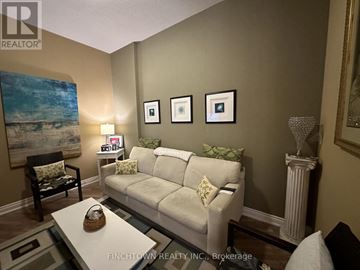 Vaughan (Maple) condo for rent - A living room with a white couch and a painting on the wall.
