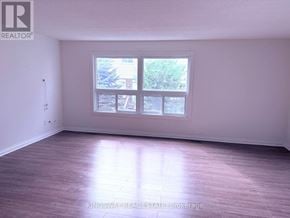 London South (South T) townhouse for rent - A room with a large window and wooden flooring.