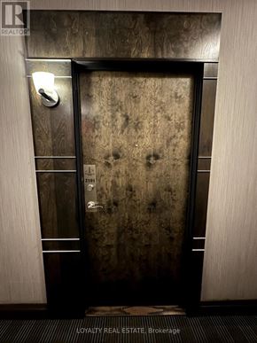 Toronto (Waterfront Communities) condo for rent - A door with a handle and a light switch on the wall.