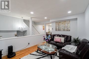 Brampton (Central Park) townhouse for rent - A living room with a brown leather couch and a glass coffee table.