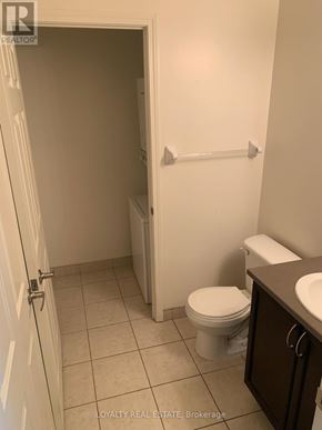 Toronto (Waterfront Communities) condo for rent - A white toilet is in a small bathroom with a white door.