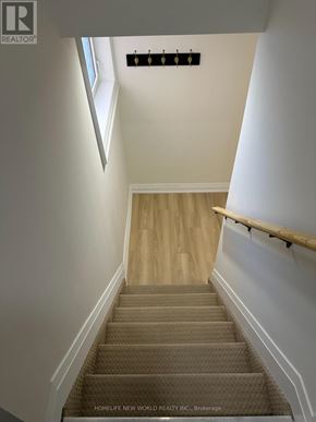 Barrie (Painswick South) apartment for rent - A staircase with a beige carpet and wooden steps.