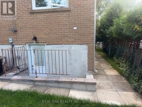 Toronto (Bayview Woods-Steeles) apartment for rent - A brick building with a white door and a metal gate.
