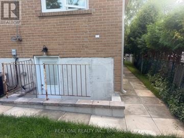 Toronto (Bayview Woods-Steeles) apartment for rent - A brick building with a white door and a metal gate.