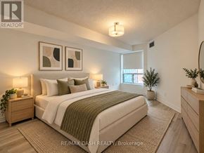 Toronto (Moss Park) condo for rent - A bedroom with a large bed, nightstands, and a plant.