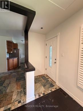 London East (East D) apartment for rent - A kitchen with a tiled floor and a white door.