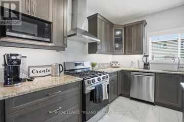 London South (South W) apartment for rent - A modern kitchen with dark wood cabinets and stainless steel appliances.
